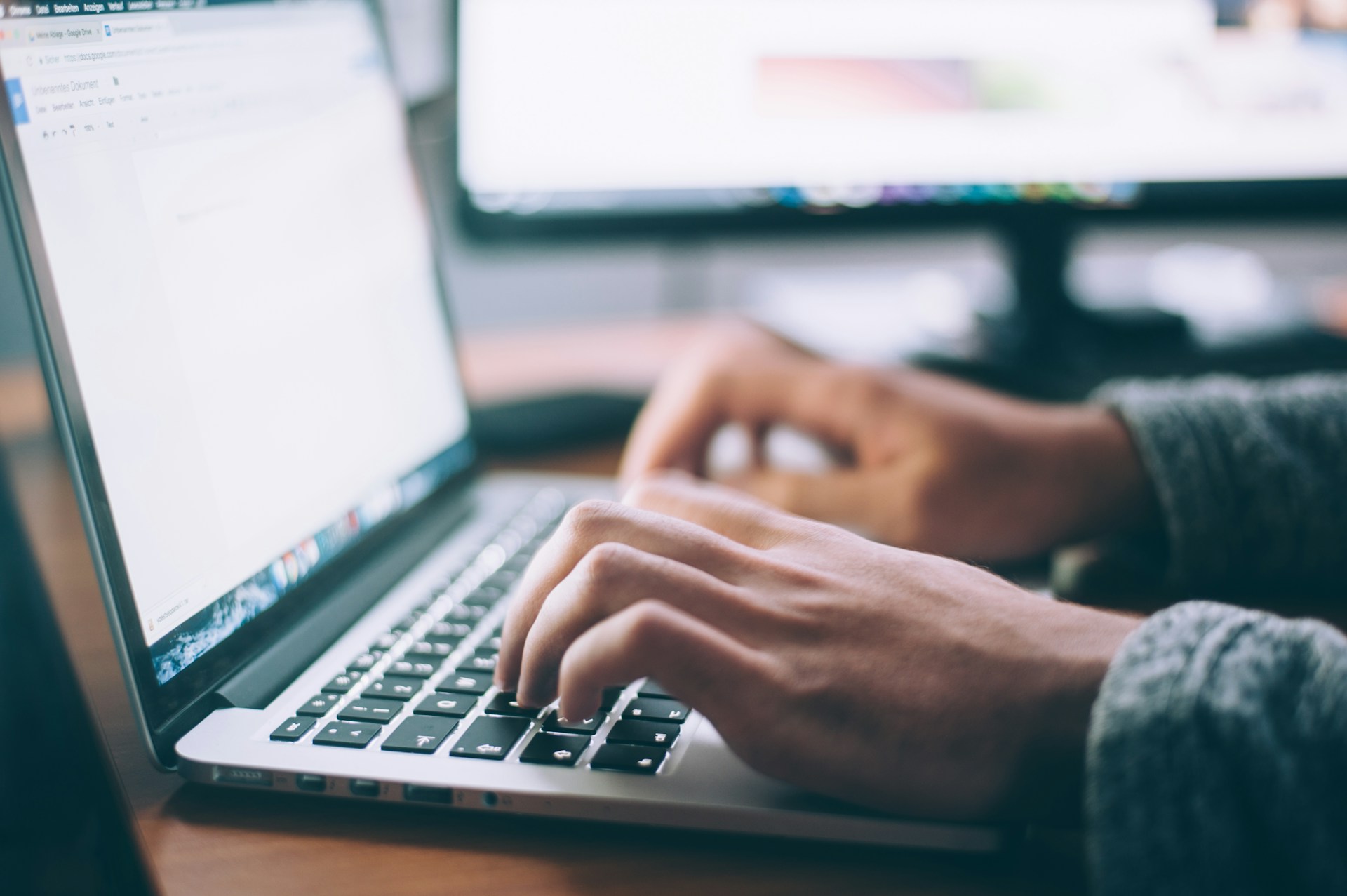 A person typing on their laptop.